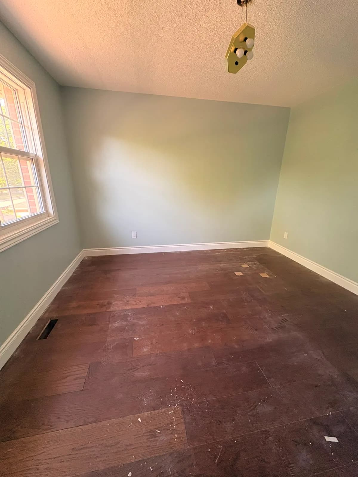 Before — Post-construction floor cleanup in a finished bedroom.